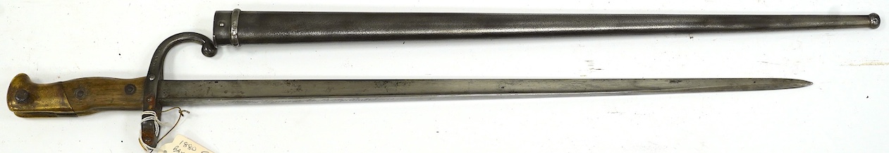 An 1880 French bayonet and scabbard for a Gras rifle. Condition - good, some pitting